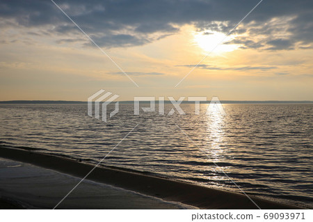 Beautiful sunset by the sea. Dark sky. Beautiful sunset by the sea. Dark sky. 69093971