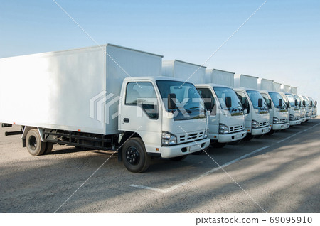 trucks stand in the parking lot in a row 69095910