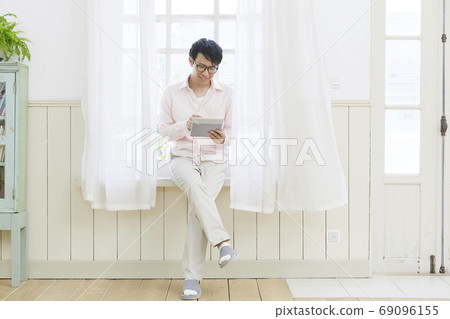 A man seeing a tablet A man seeing a tablet 69096155