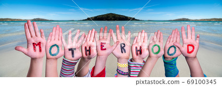 Children Hands Building Word Motherhood, Ocean Background Children Hands Building Word Motherhood, Ocean Background 69100345