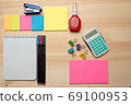 The top view of creative desk with office accessories, notebooks and colorful stickers. Wooden background with copy space for inscription. 69100953
