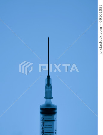 medical syringe on a dark background medical syringe on a dark background 69101083