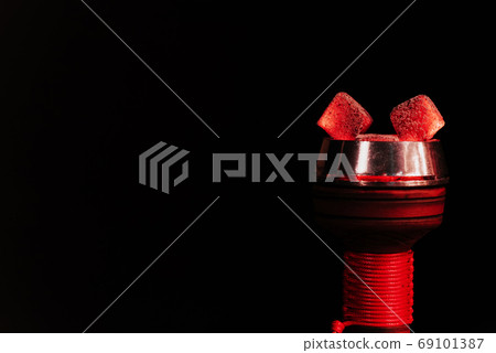 red hot coals of a hookah in a shisha bowl on a black background red hot coals of a hookah in a shisha bowl on a black background 69101387