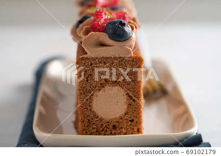 Chocolate cake with chocolate cream decoration and berries. Gourmet cake. Chocolate cake with chocolate cream decoration and berries. Gourmet cake. 69102179