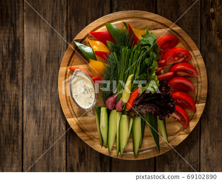 dish on a wooden surface dish on a wooden surface 69102890