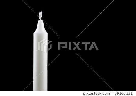 Single White Candle Against a Black Background Single White Candle Against a Black Background 69103131