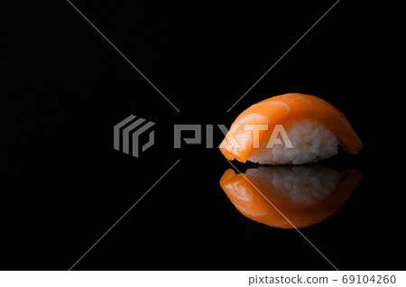 close-up of sushi with rice on black background with reflection close-up of sushi with rice on black background with reflection 69104260