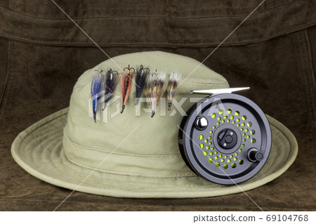 Fishing Flies on Hat with Fly Fishing Reel on Outdoor Coat 69104768