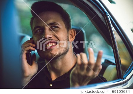 Passenger businessman use a smartphone in the back Passenger businessman use a smartphone in the back 69105684