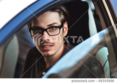 Close up side portrait of caucasian man driving Close up side portrait of caucasian man driving 69105686