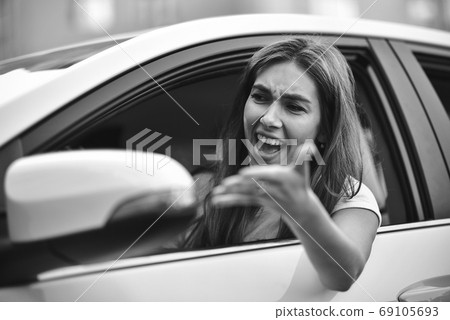 Young girl driving a car shocked about to have Young girl driving a car shocked about to have 69105693