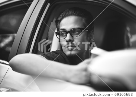 Close up side portrait of caucasian man driving Close up side portrait of caucasian man driving 69105698
