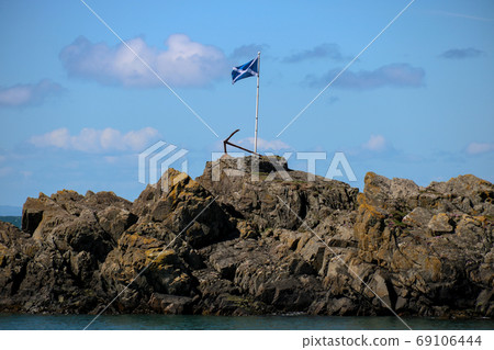 Scottish Flag and Rusting Anchor at a Scottish Harbour 69106444