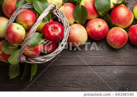 Ripe garden apple fruits in basket 69106590
