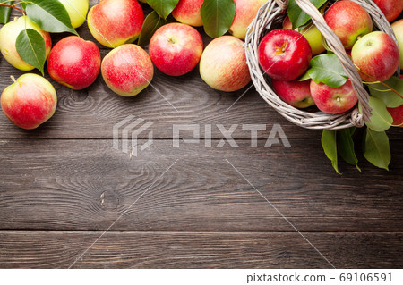 Ripe garden apple fruits in basket 69106591