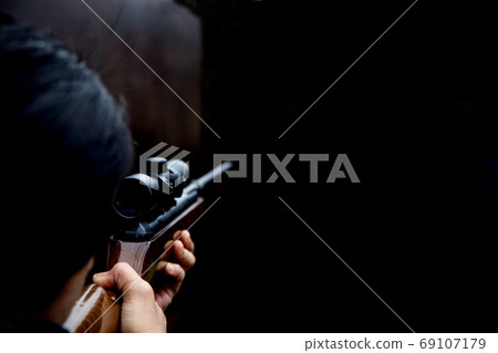 Woman Shooting at a Rifle Range 69107179