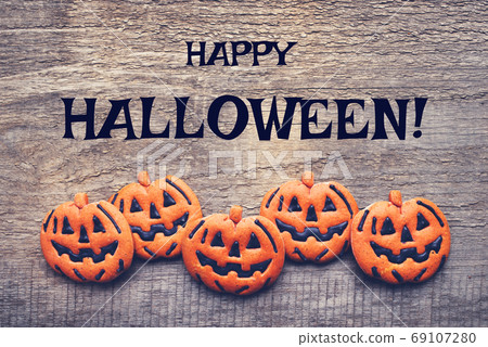 Halloween gingerbread cookies on wooden background. Halloween gingerbread cookies on wooden background. 69107280
