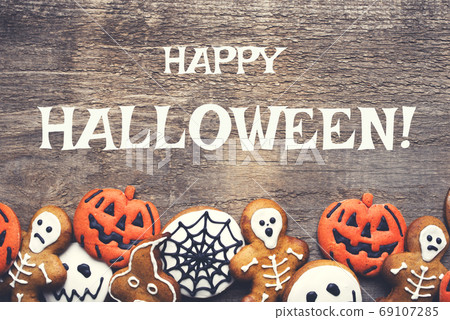 Halloween gingerbread cookies on wooden background. Halloween gingerbread cookies on wooden background. 69107285