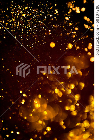 Golden abstract bokeh on black background. Golden abstract bokeh on black background. 69107286