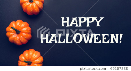 Dark background with three pumpkins. Dark background with three pumpkins. 69107288