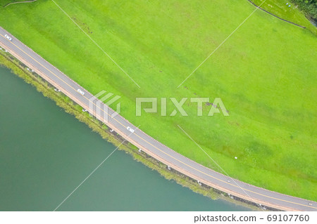 landscape of road with grassland near the lake 69107760