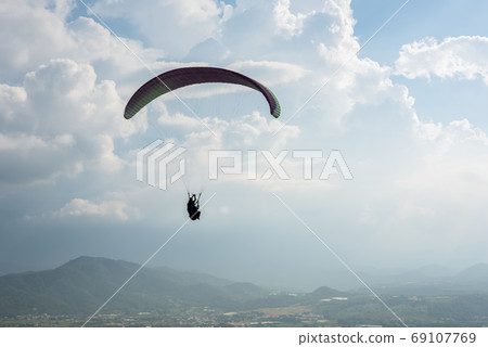 colorful paragliding over blue sky at town 69107769