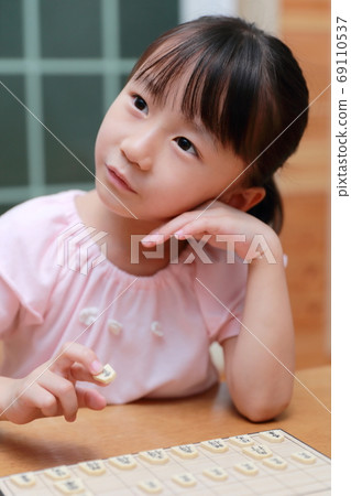 A girl playing shogi 69110537