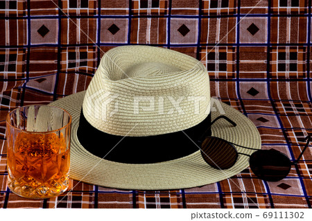 Panama Hat with Sunglasses and Drink on a Beach Sarong 69111302