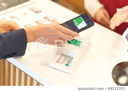 Hand of man making payment with IC card Hand of man making payment with IC card 69112355