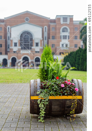 Close up shot of a Oak barrel with many flowers 69112555