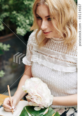 Young woman writing in diary Young woman writing in diary 69114087