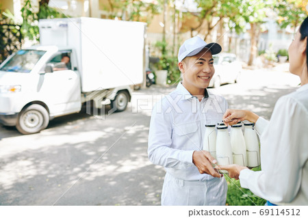 Deliverying milk bottles Deliverying milk bottles 69114512