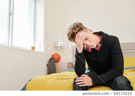 Boy suffering from headache Boy suffering from headache 69115619