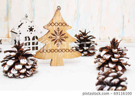Christmas and New Year composition of fir cones and wooden Christmas tree toys Christmas and New Year composition of fir cones and wooden Christmas tree toys 69116100