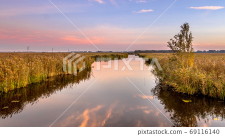 River through marshland 69116140