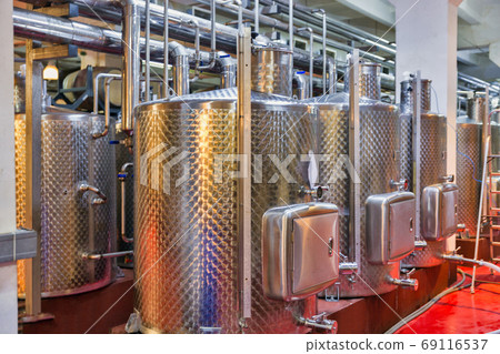 Stainless steel reservoirs for wine at modern winery. 69116537