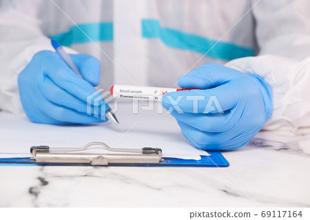 laboratory technician hand holding blood test tube  69117164