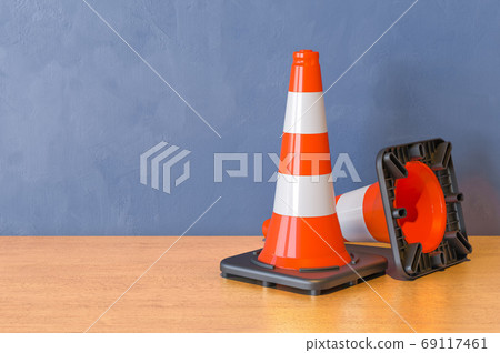 Two Road Cones on the wooden table. 3D rendering Two Road Cones on the wooden table. 3D rendering 69117461