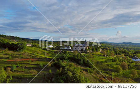 Landscape a small village in a mountainous area on a spring sunny day Karpaty Ukraine 69117756