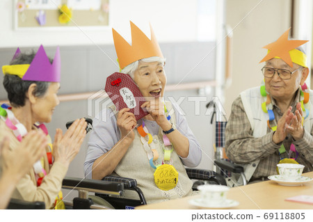 Senior man and woman nursing home for a birthday party 69118805