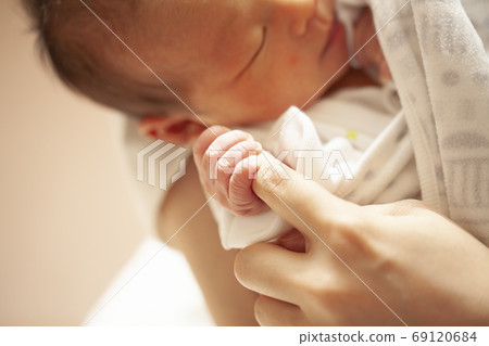 Baby hand holding mother's fingers Baby hand holding mother's fingers 69120684