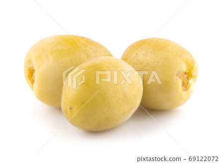 yellow raw dates an isolated on white background 69122072