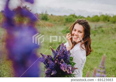 woman at blooming lupines field 69123663