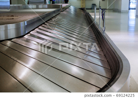 Baggage conveyor waiting for on airport after 69124225