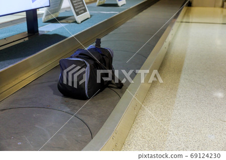 Suitcase in the airport international tourists Suitcase in the airport international tourists 69124230