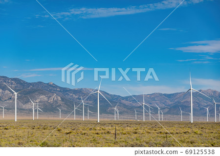 Sunny view of many windmill in a rural area Sunny view of many windmill in a rural area 69125538