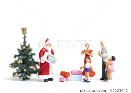 Miniature people : Santa Claus holding gift for happy family , Christmas and Happy New Year concept. Miniature people : Santa Claus holding gift for happy family , Christmas and Happy New Year concept. 69125642