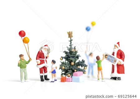 Miniature people : Santa Claus holding gift for happy family , Christmas and Happy New Year concept. Miniature people : Santa Claus holding gift for happy family , Christmas and Happy New Year concept. 69125644