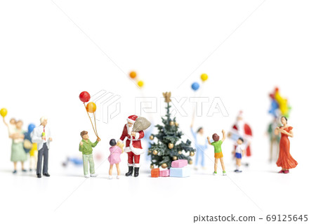 Miniature people : Santa Claus holding gift for happy family , Christmas and Happy New Year concept. Miniature people : Santa Claus holding gift for happy family , Christmas and Happy New Year concept. 69125645