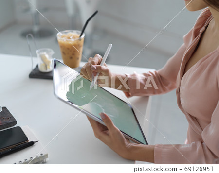 Close-up view of young businesswoman planing her work on mock up 69126951